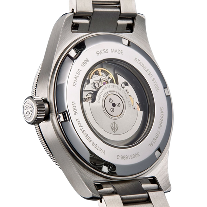 Back view of a silver watch with visible mechanism and Khalsa log